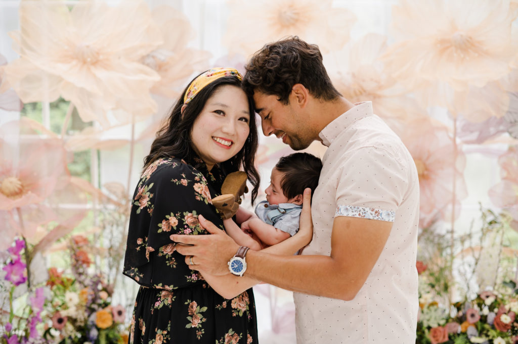 Mom, Dad, and newborn  at The Mother's Day Session